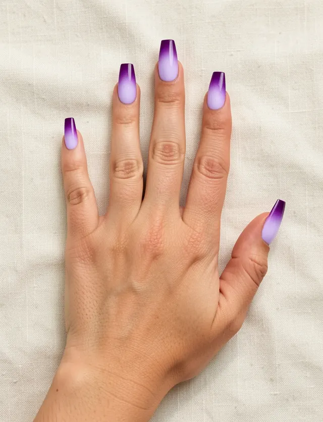 Long coffin nails with a glowing lavender center fading to deep violet edges