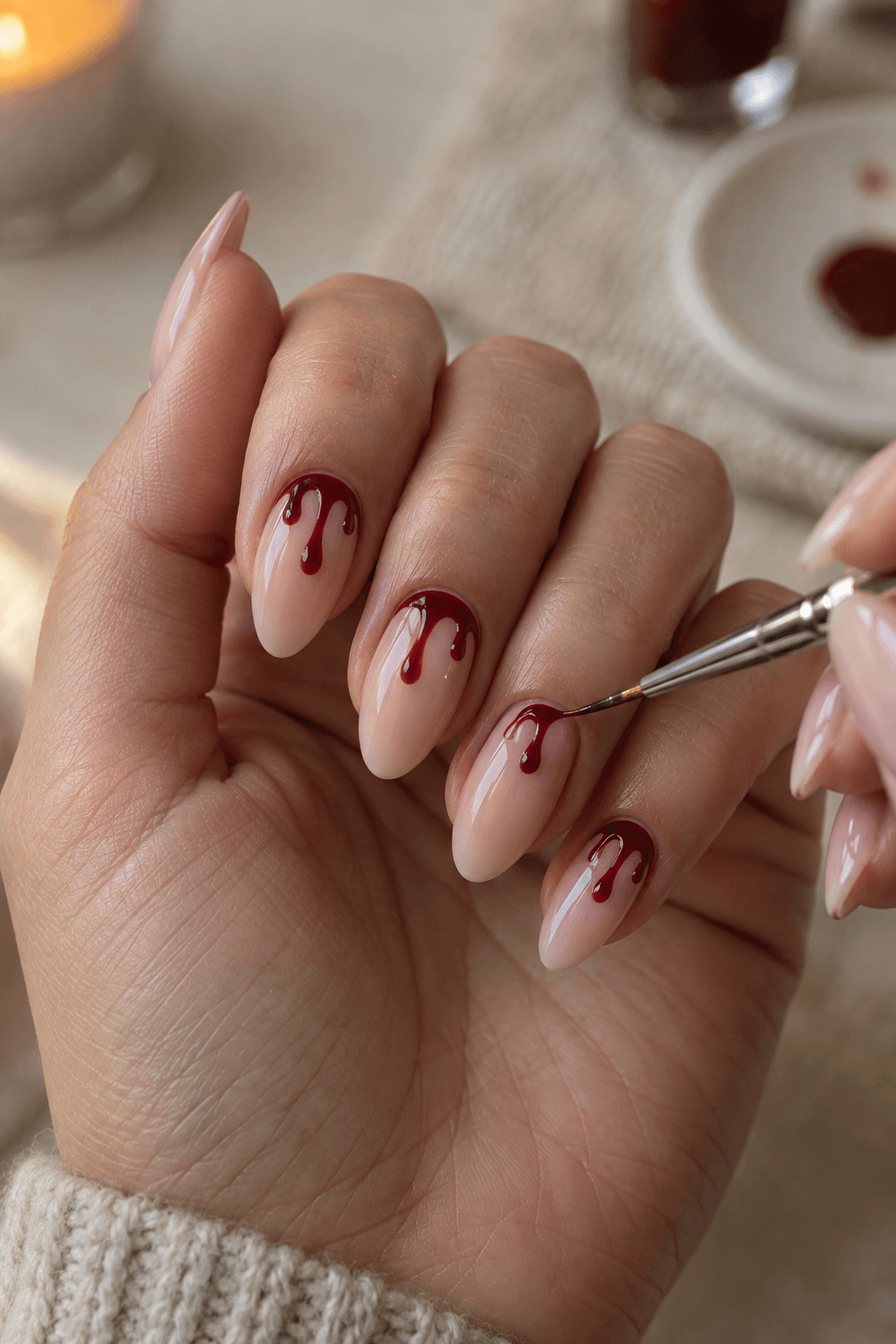 Fine brush creating a crimson drip detail