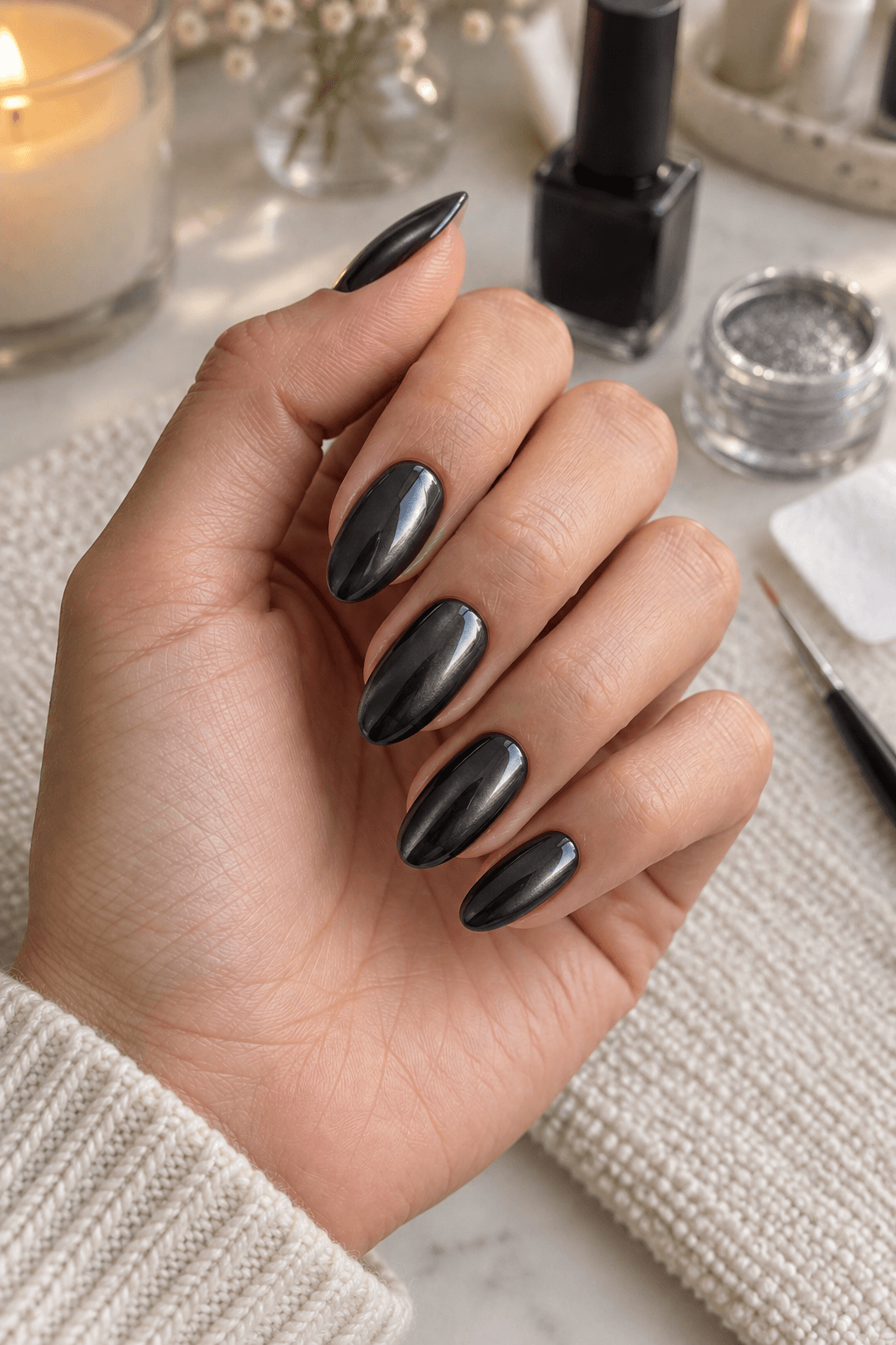 Charcoal chrome base nails beside manicure tools before ghost details are added