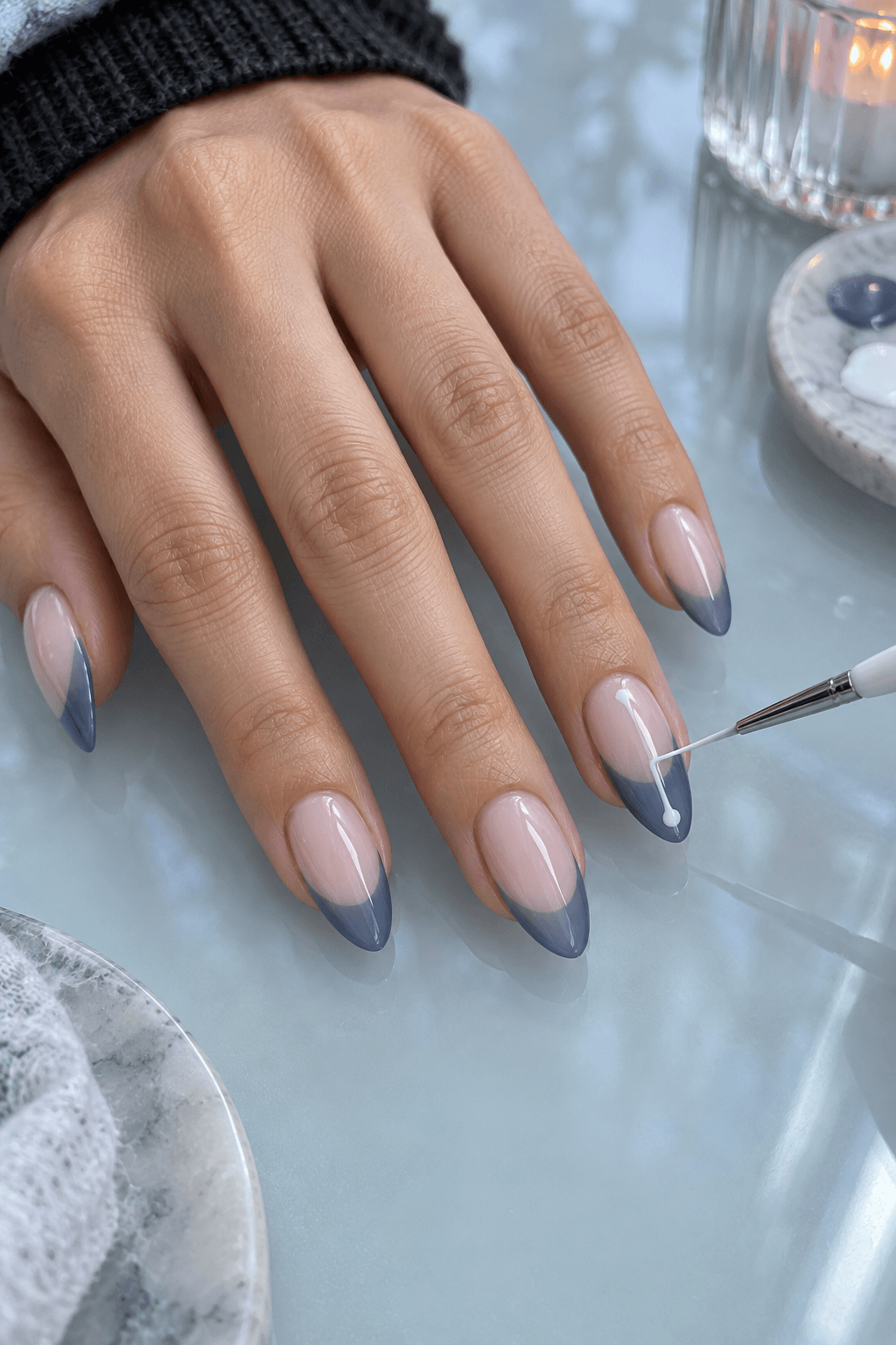 Fine white liner drawing a slim bone line over a translucent blue French tip